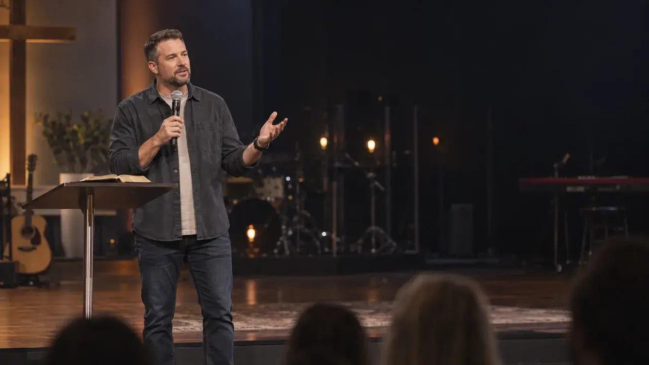 A sample sermon recording: a preacher on a stage holding a microphone.